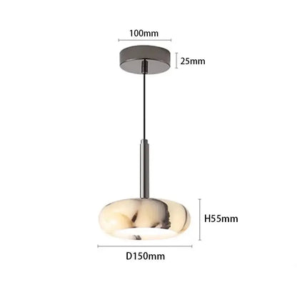 Modern bedside pendant light with white marble oval glass shade featuring cream and black veining suspended by black cord