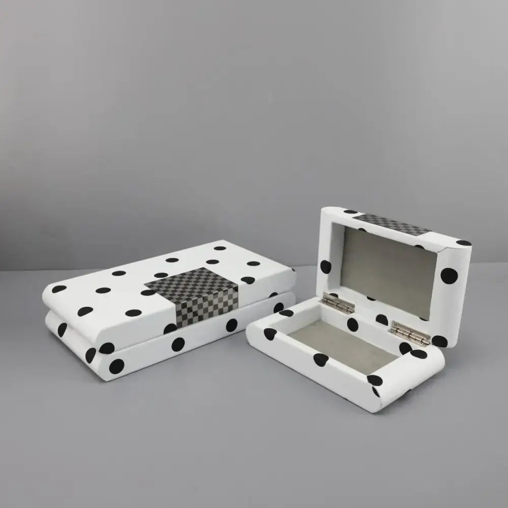 Modern white and black polka dot leather storage box with checkered accents and silver hinges for bedroom organization