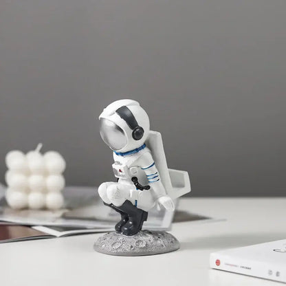 Modern white and blue astronaut resin figurines with reflective silver helmet on textured lunar surface base decorbites astronaut resin