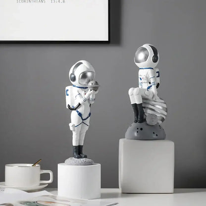 Modern white and blue astronaut resin figurines by decorbites featuring silver helmets for living room decor