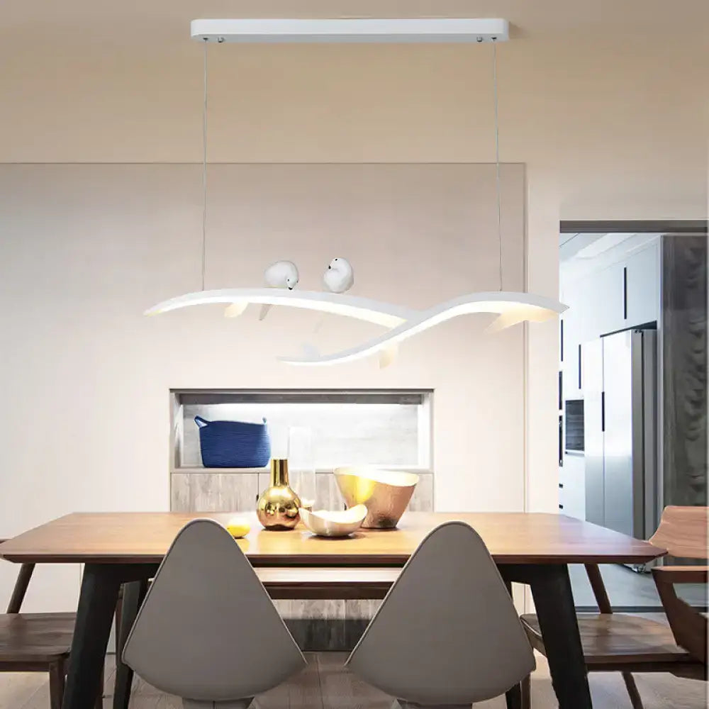 Modern white branch led island light with acrylic design and bird accents emitting warm white light