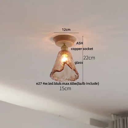 A warm-toned hand-blown glass pendant light with copper socket and ash wood base for modern ceramic led ceiling lamp use