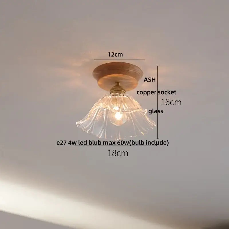 Modern white and brass ceramic led ceiling lamp with a delicate clear glass pendant and wooden ceiling mount