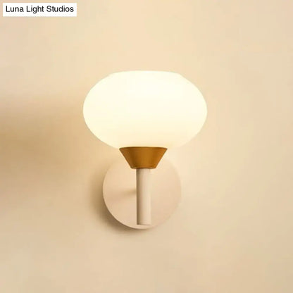 Modern white and brass wall sconce with opal glass frosted globe and conical base for 220v-240v bedroom lighting