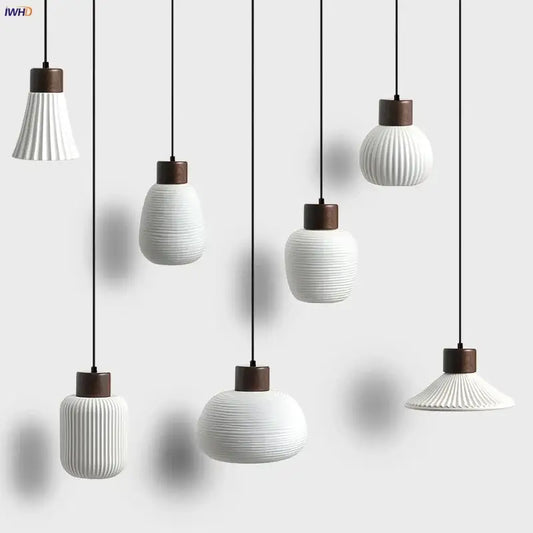 Modern white ceramic pendant light fixture with vertical ridges and dark wood accents for kitchen decor