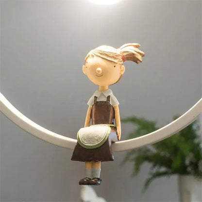 A beige resin figurine of a girl with blonde ponytail in brown overalls paired with modern white ceramic bird iron ring pendant light decorbites iron ring pendant