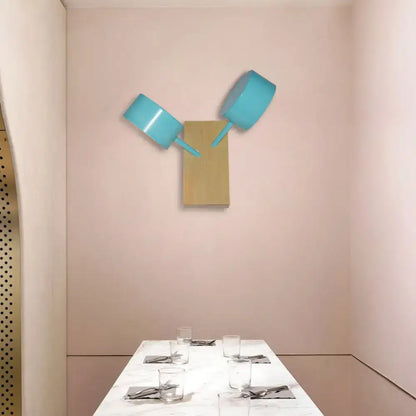 Two turquoise metallic cooking pots mounted as wall art sculpture complement modern white ceramic double drum wall sconce 110v-120v