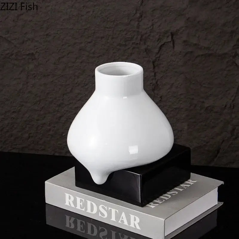 A sleek glossy white ceramic liquid vase with a modern bulbous shape and narrow neck by decorbites ceramic
