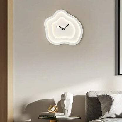 Modern white cloud led wall lamp with glowing illumination and minimalist black hands for bedroom decor