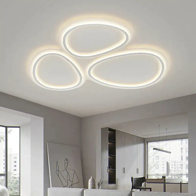 Modern white cloud ring led ceiling light with three interconnected oval rings emitting warm glow for living room decorbites circular lumines panel