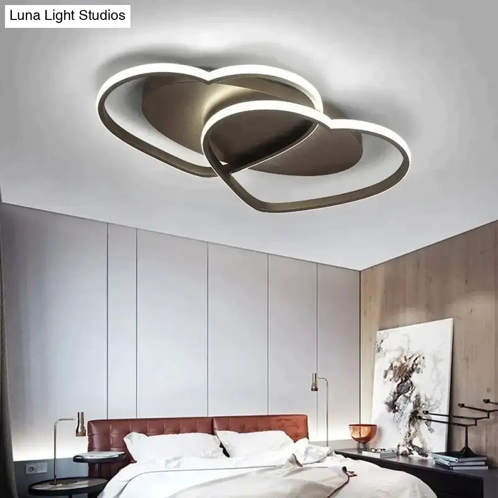 Modern white coffee pendant light featuring double-heart-shaped metallic frame with glowing led illumination for bedroom