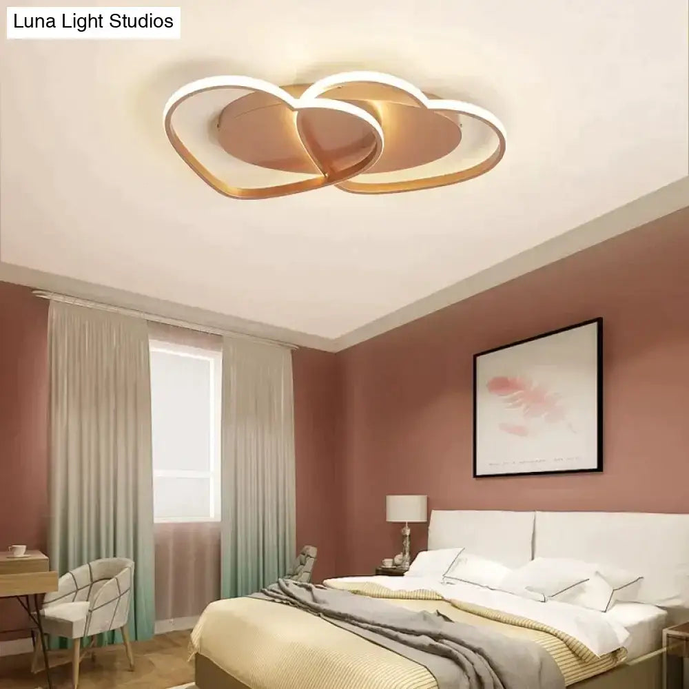 Modern white coffee pendant light with gold-toned interlocking heart rings and glowing led rings for bedroom use