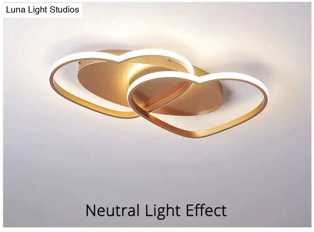 Gold-toned led pendant light with two interlocking heart-shaped rings for modern white coffee bedroom decor