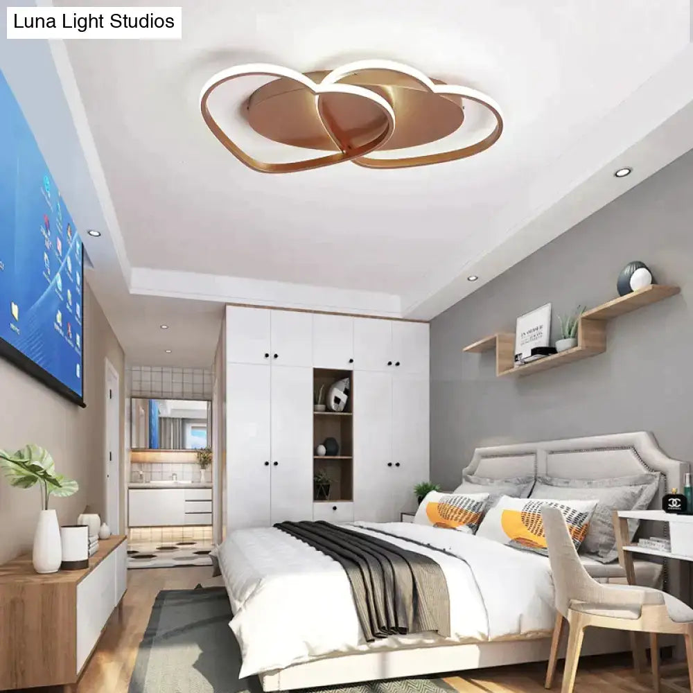 Modern white coffee pendant light with copper-toned cloud-shaped design and sleek interlocking rings for bedroom