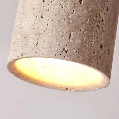 Modern white concrete pendant light with textured beige surface providing warm glow for kitchen lighting area