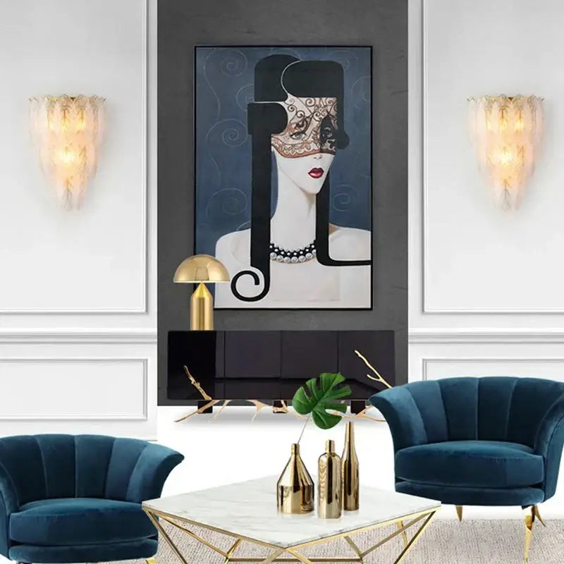 Portrait painting of a black and gold ornate mask with intricate lace detailing alongside modern white crystal feather wall lamp decorbites crystal feather sconce