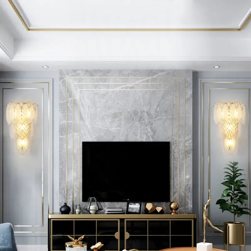 Modern white crystal feather wall lamp with gold pearl sconce on gray marble accent wall with gold trim and tv decorbites crystal feather