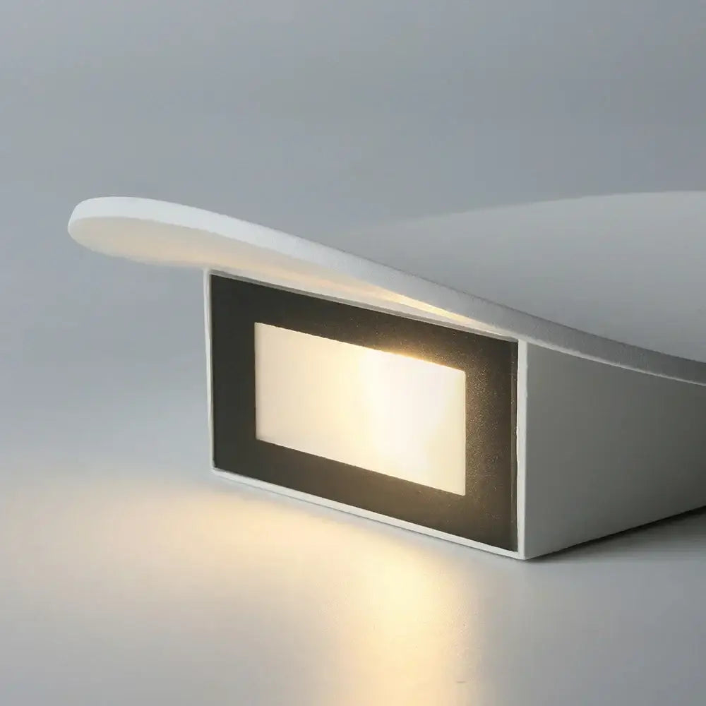 Modern white curved led wall lamp with sleek design and warm glow for bedroom lighting as an elegant led wall lamp
