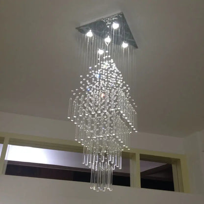 A modern white decorbites crystal ceiling chandelier with a square metal mount and cascading clear glass rods