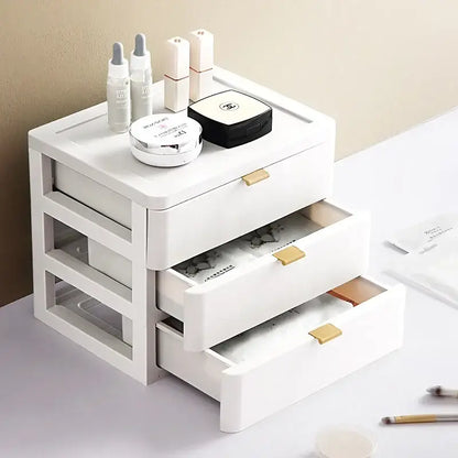 Modern white plastic decorbites desktop organizer drawer with three gold handles topped with cosmetic items