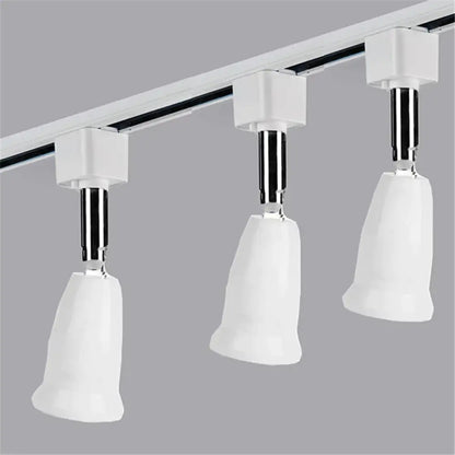 Modern white dimmable led track lighting fixture with ceramic bell-shaped heads and chrome adjustable arms for living room art