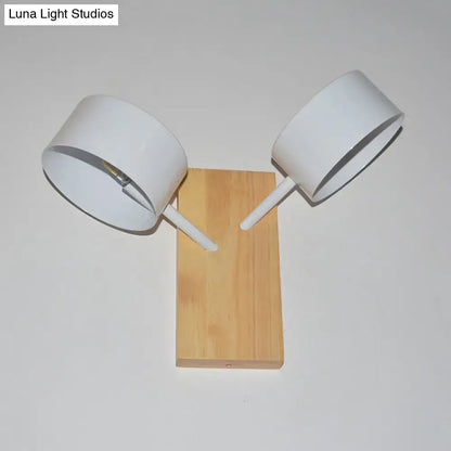 Modern white dual drum wall light with two adjustable arms and natural wood base ideal as a bedroom wall light 220v-240v 110v-120v