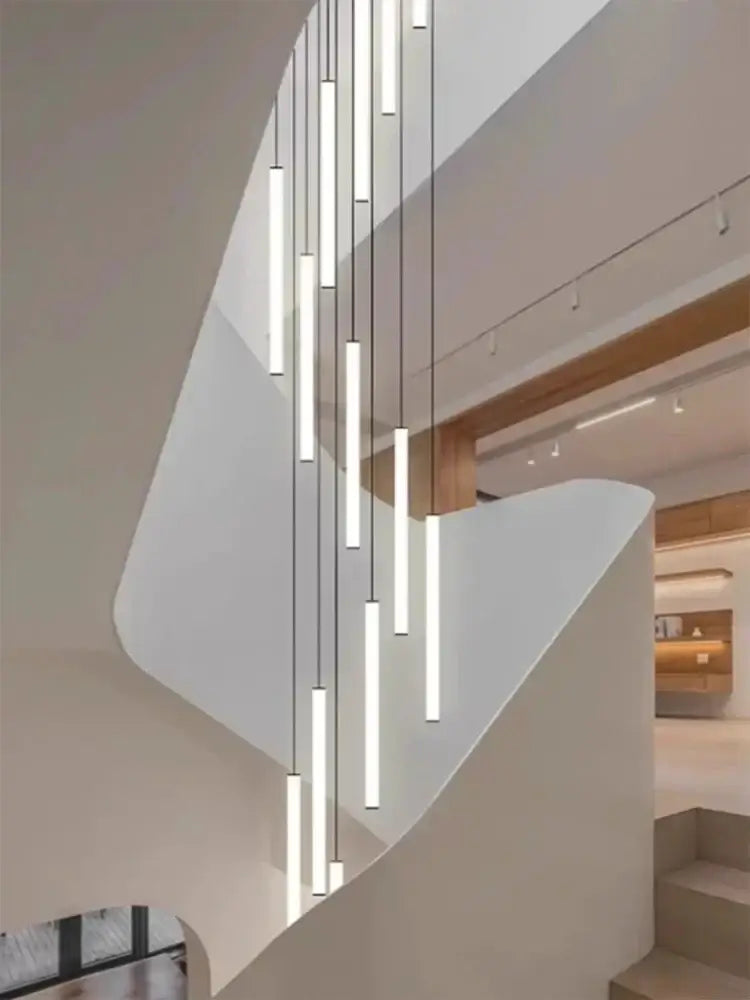 Modern white duplex loft led chandelier with sleek vertical pendant lights suspended on thin black cords decorbites duplex loft