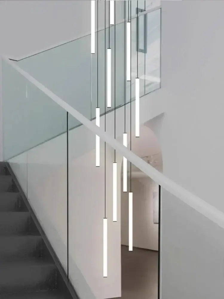 Modern white duplex loft led chandelier featuring minimalist cylindrical white led tubes suspended by black cords decorbites duplex loft