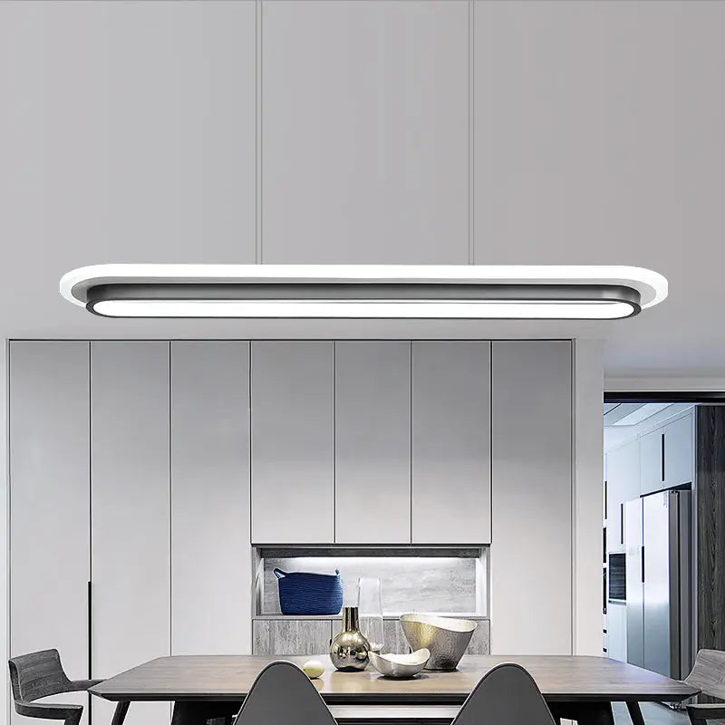 Modern minimalist pendant light with white elliptical island design featuring black trim for table lighting by decorbites