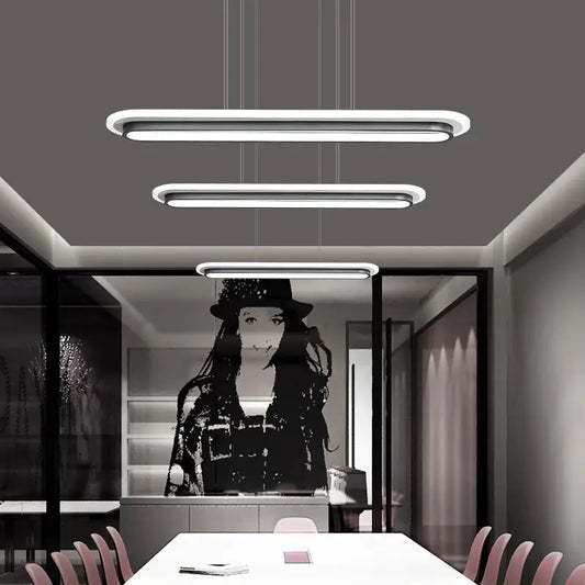 Three sleek modern white elliptical island led ceiling lights with minimalist acrylic design for table lighting