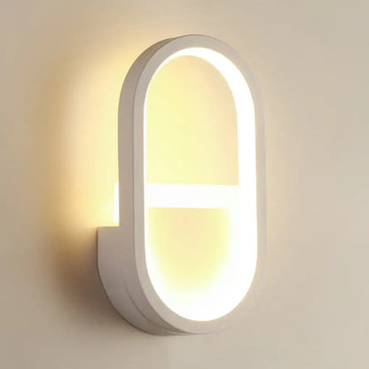 Modern white elliptical led wall lamp with sleek minimalist design and warm lighting for bedroom sconce use