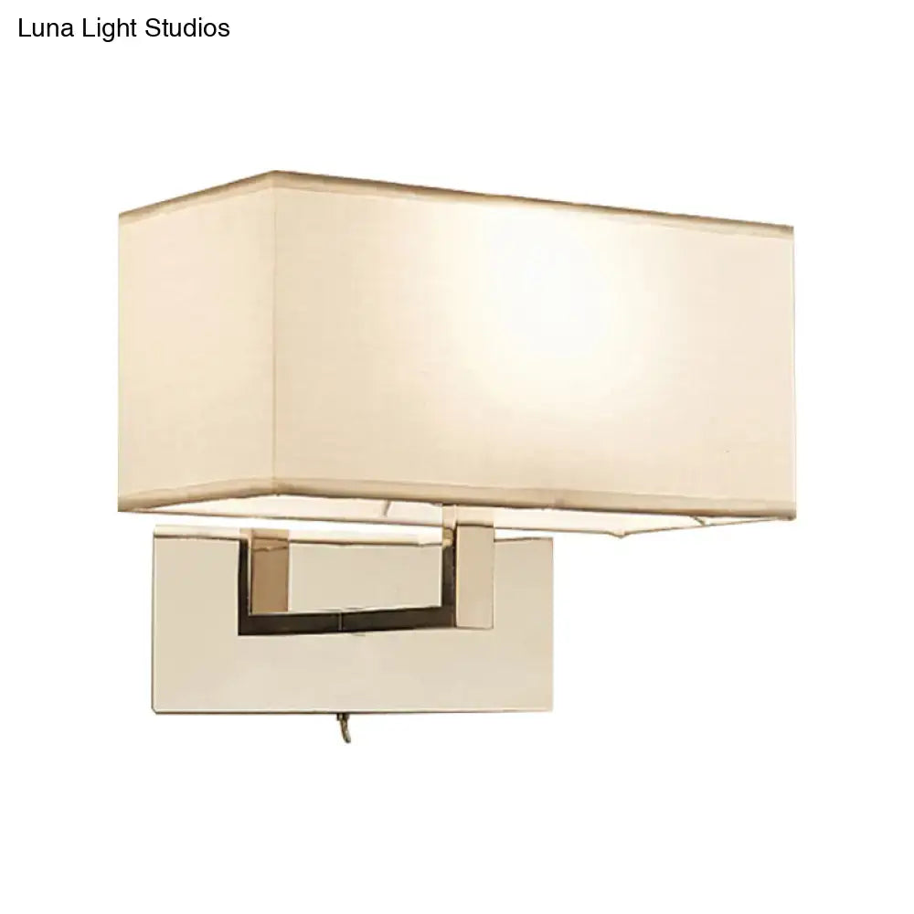 Modern white wall sconce with cream fabric shade and polished chrome frame for bedroom wall light