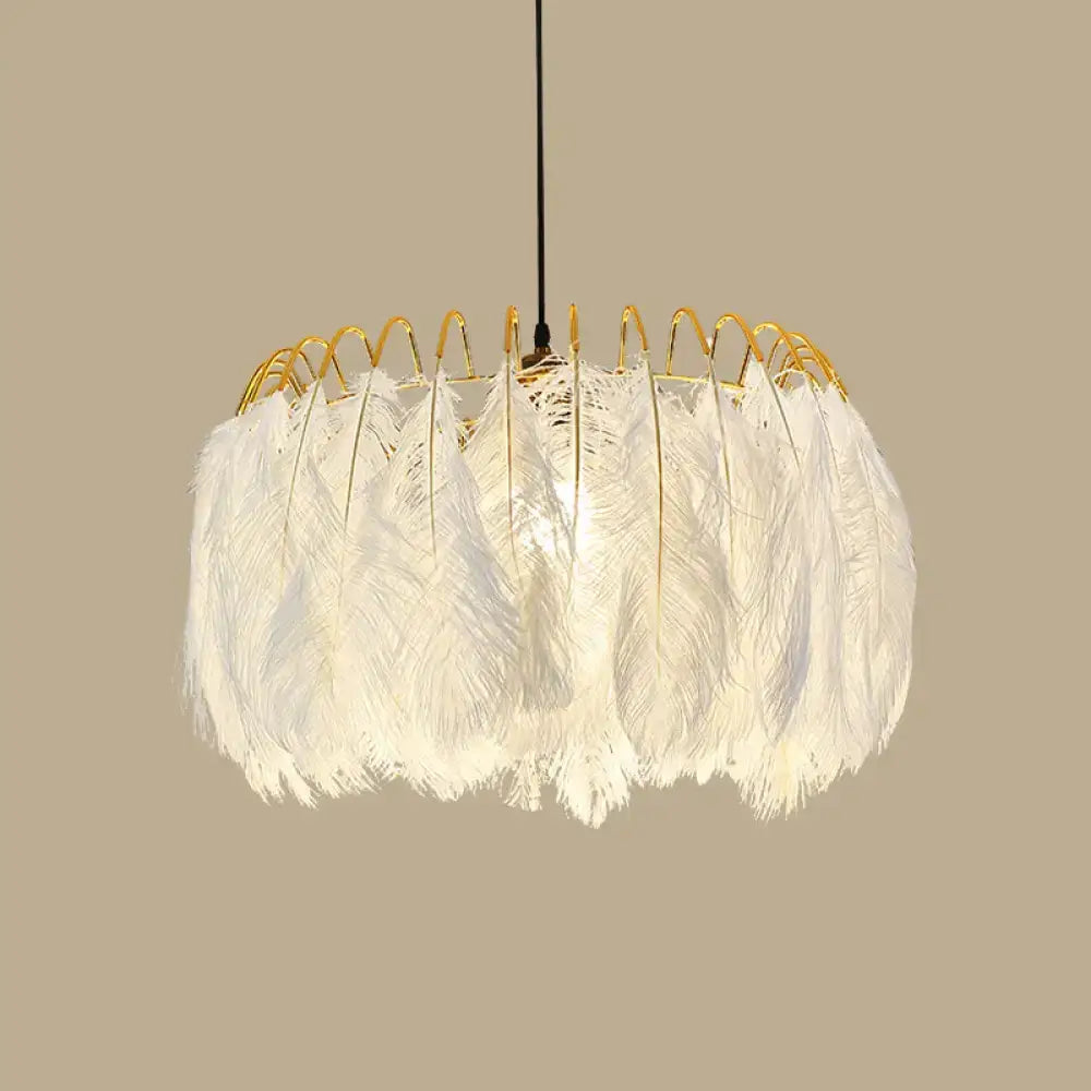 Modern white feather chandelier with gold wire frame designed as a living room pendant light fixture