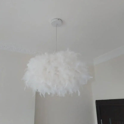 Modern white feather pendant light with a fluffy white feather design and chrome finish hanging from ceiling mount