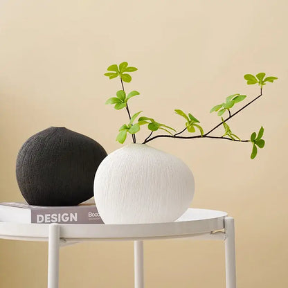 White ceramic vase with a textured brushed finish and geometric stripes ceramic design for modern living room decor
