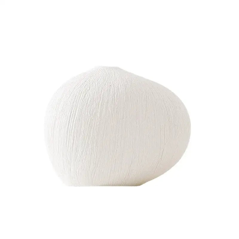 Modern white geometric stripes ceramic vase with textured vertical ridges ideal for living room decor by Decorbites
