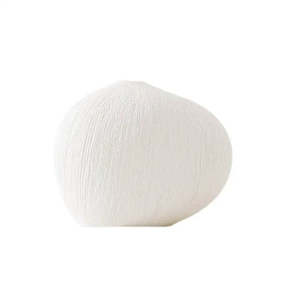 Modern white geometric stripes ceramic vase with textured vertical ridges ideal for living room decor by Decorbites