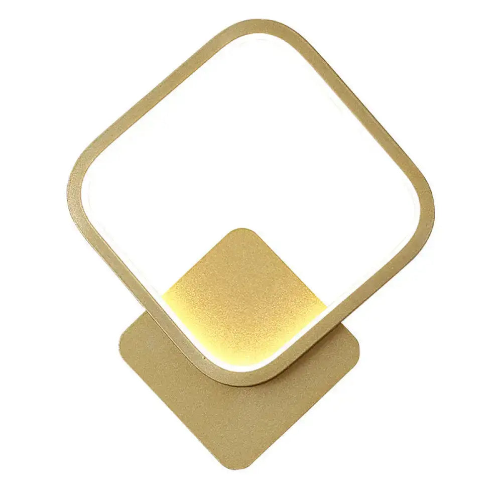 Modern gold-finished wall lamp with white geometric twisted design and softly glowing led light for stairway use