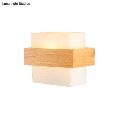 Minimalist modern wall light with warm glow featuring stacked white glass acrylic and light wood elements for bedroom use
