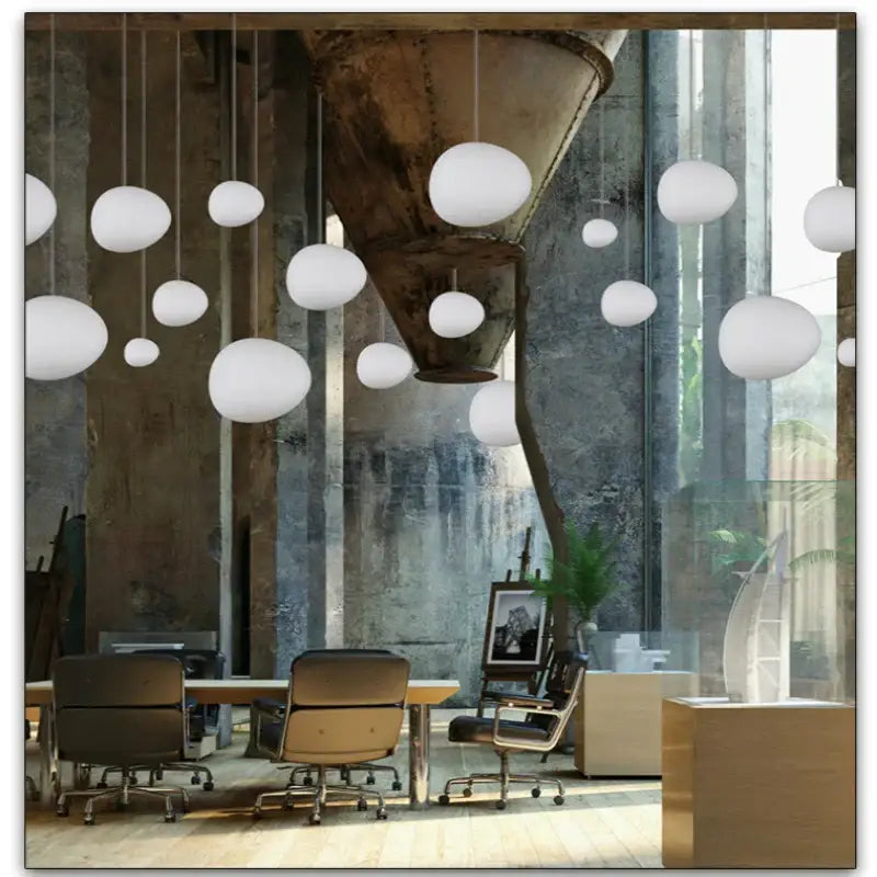 Modern white glass ball led pendant light hanging in an industrial dining room featuring decorbites glass ball design