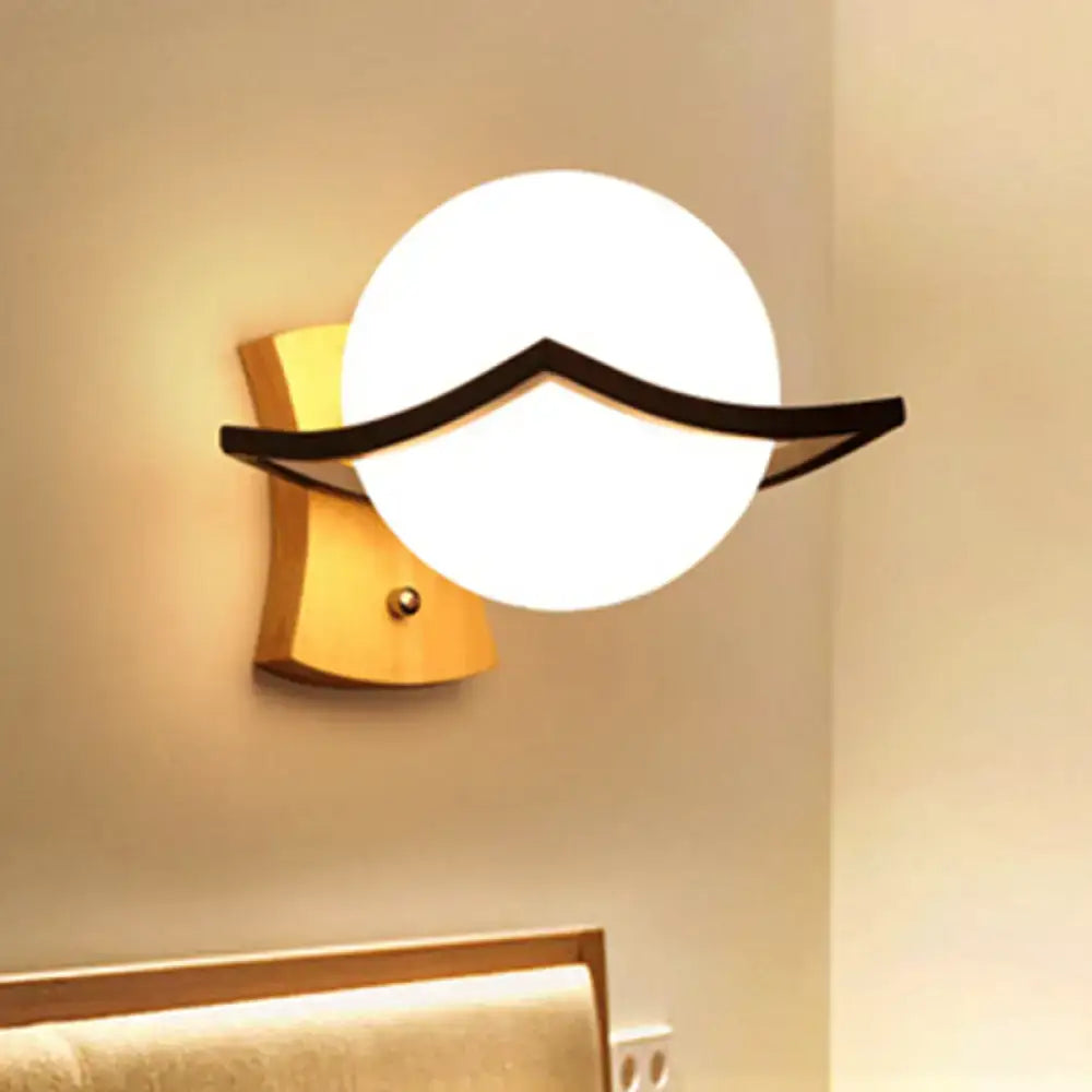 Modern white glass ball sconce with black accent and warm wooden base is a great addition as a direct wired electric lamp
