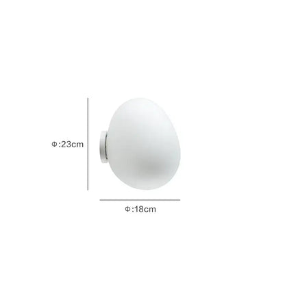 Modern white glass egg wall lamp with frosted globe and metallic base for bedroom wall sconces installation