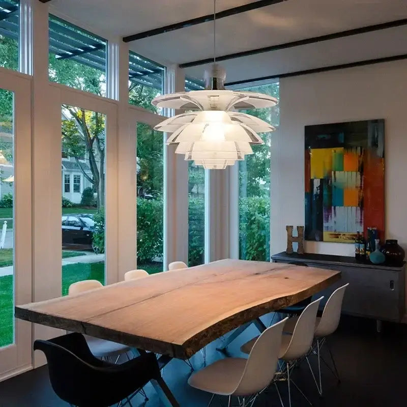 Modern white glass pine cone pendant chandelier with layered petal design hanging above dining table