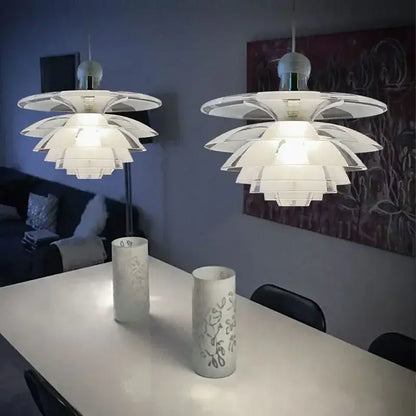 Two white glass pine cone pendant lights with layered petals in a modern cone pendant chandelier for living room