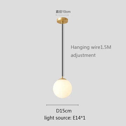 Modern white globe pendant light with gold finish, frosted glass white globe shade, and black hanging wire for kitchen or dining room