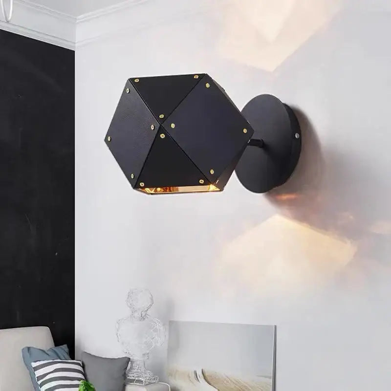 Black hexagonal wall sconce with gold-toned accents and matte finish complements decorbites cube led pendant light decor