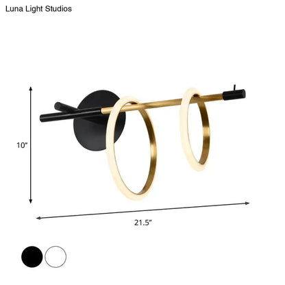 Modern white and gold ring light fixture wall light with sleek black base and two glowing gold rings minimalist design