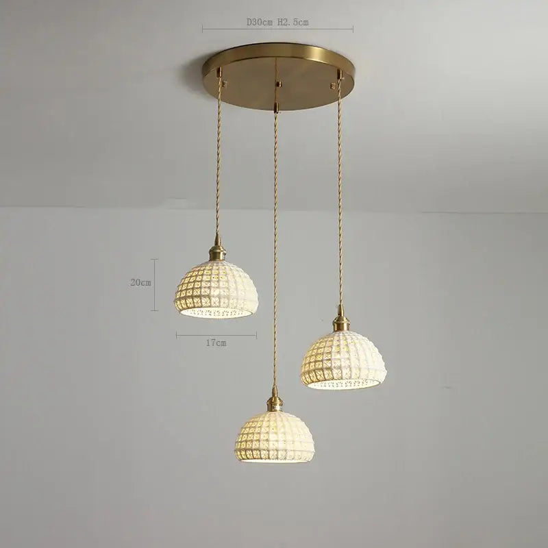 Three ceramic led pendant lights with gold metal fixtures and woven glass shades for modern dining room decorbites ceramic led