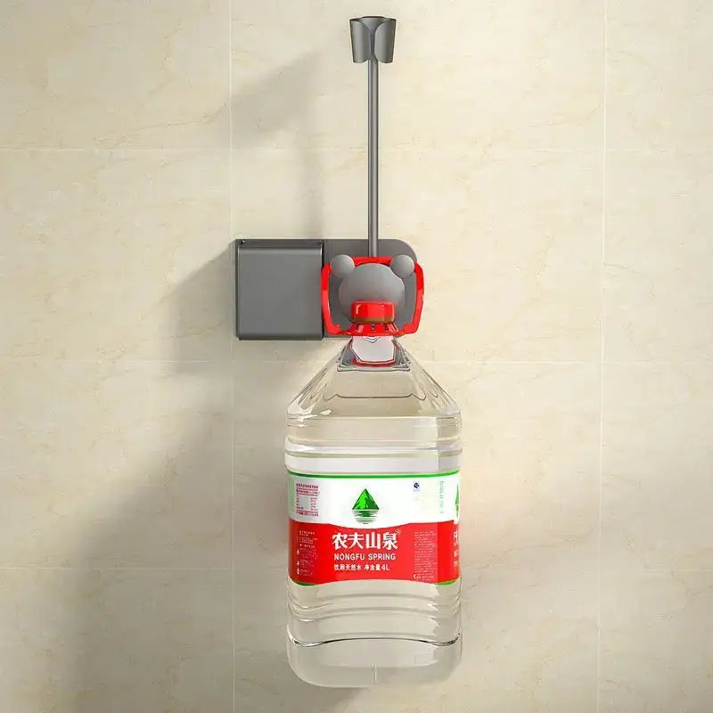 Gray and red bear-shaped bottle opener mounted on wall holding water bottle on modern white and gray bathroom hair dryer rack