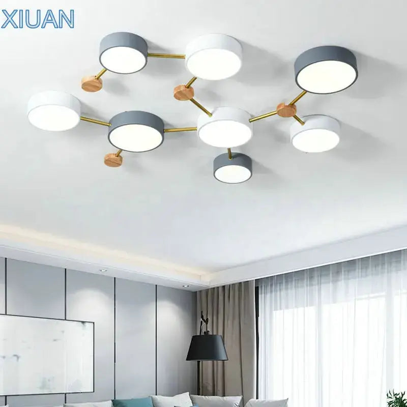 Modern white and gray wood ceiling chandelier with circular bulbs connected by gold metal arms for living room lighting